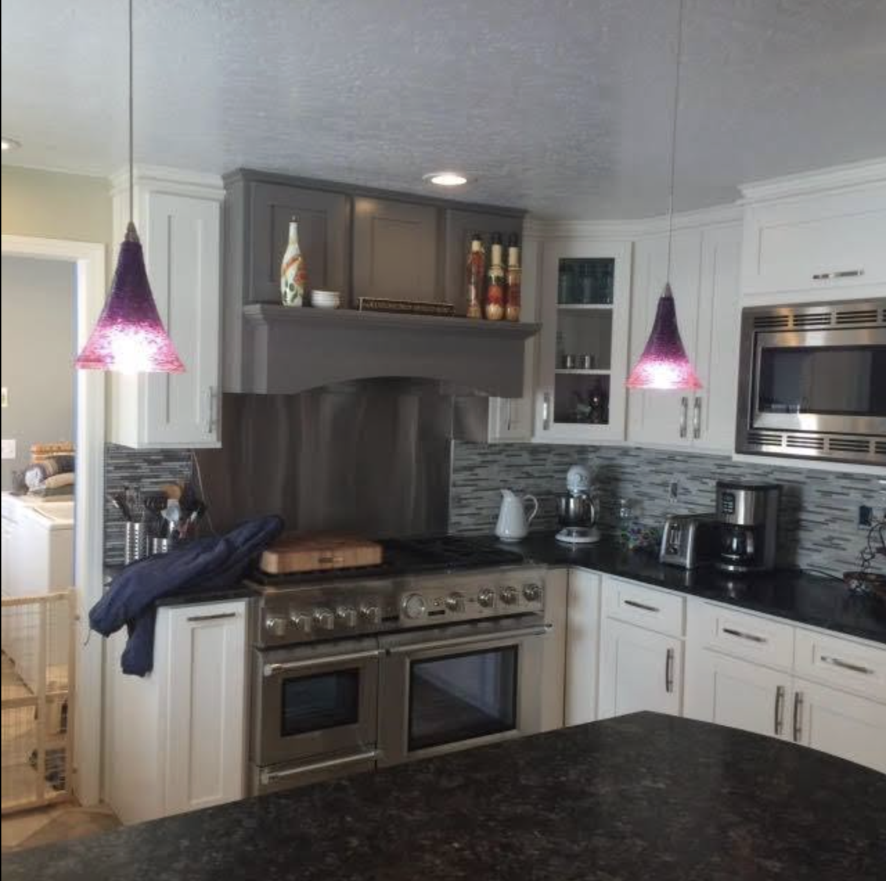 Kitchen remodel with two-tone cabinetry and pendant lighting