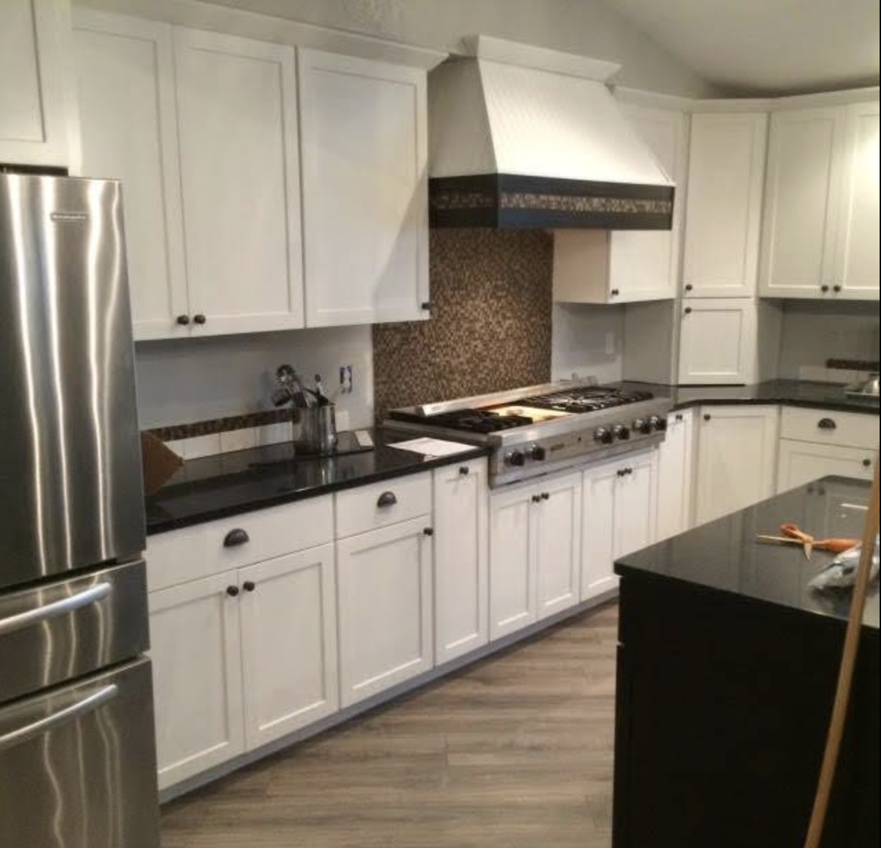 White cabinetry kitchen with custom range hood