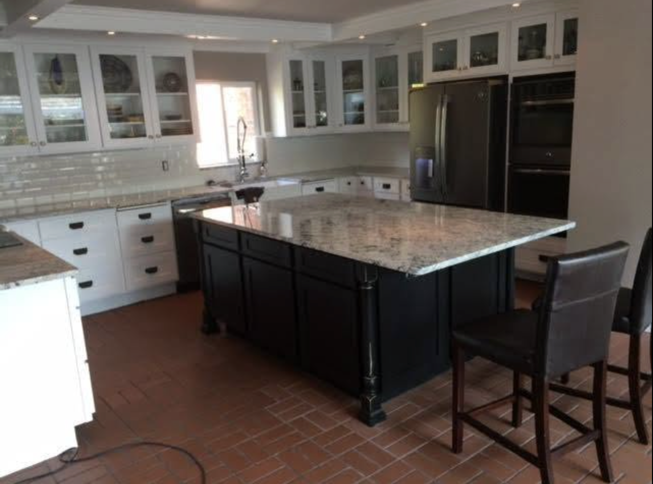 Kitchen remodel with glass-front cabinets and granite island